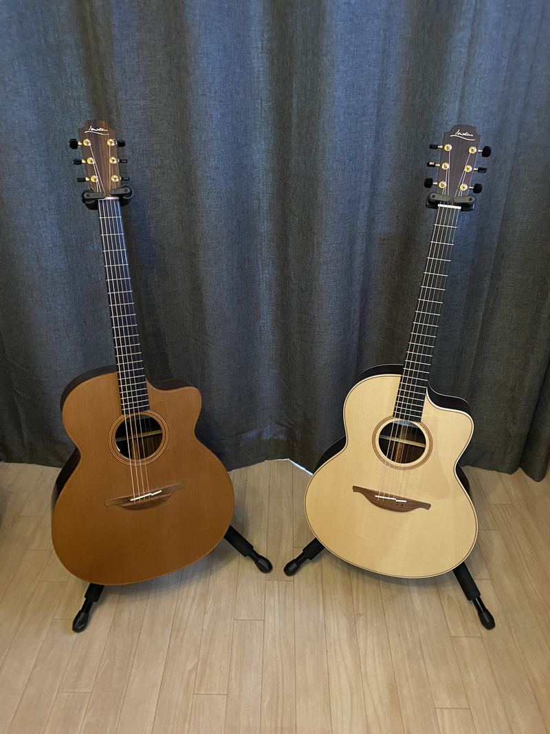 Two of Tom's acoustic guitars on stands